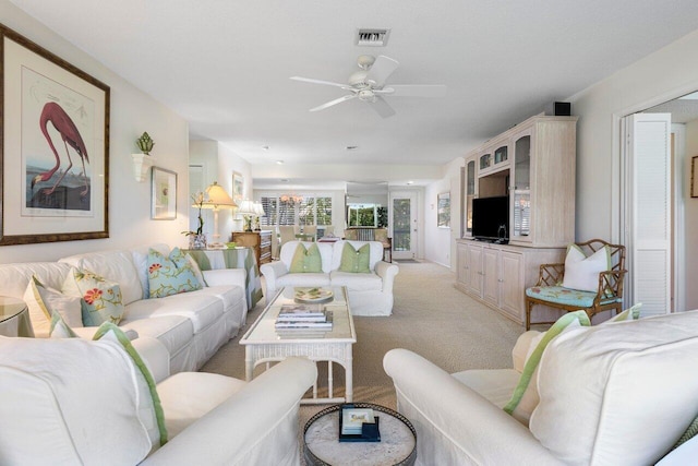 carpeted living room featuring ceiling fan