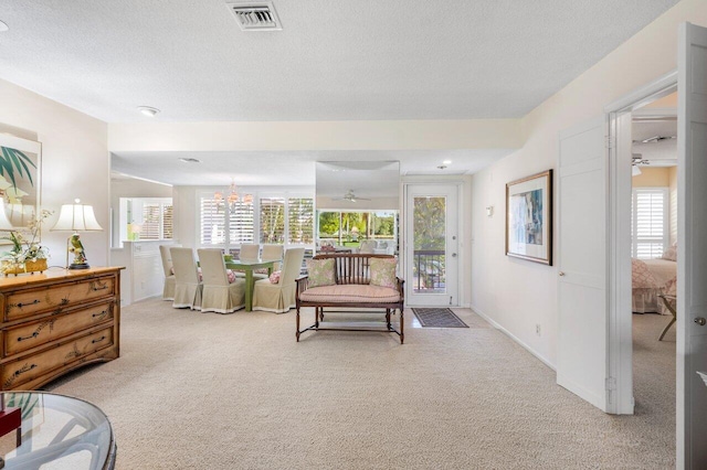 living room featuring light carpet and a textured ceiling