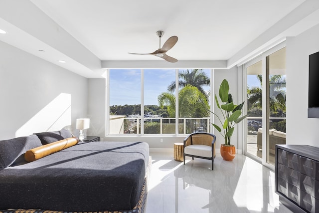 bedroom with multiple windows, access to exterior, and ceiling fan