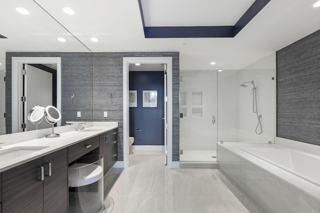 full bathroom featuring vanity, a raised ceiling, plus walk in shower, and toilet