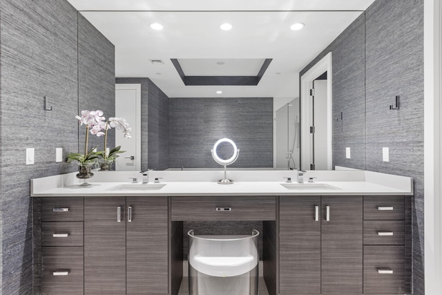 bathroom with vanity and tile walls