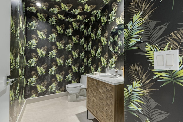 bathroom featuring vanity, toilet, and tile patterned flooring