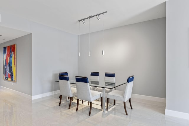 dining space featuring track lighting