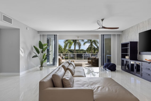 living room with floor to ceiling windows and ceiling fan