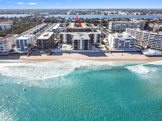 aerial view with a water view and a view of the beach