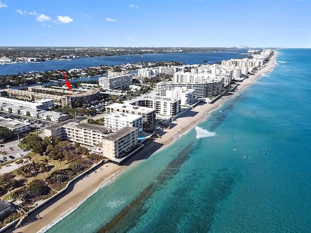 birds eye view of property with a water view and a view of the beach