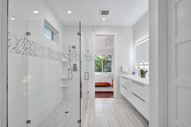 bathroom with a shower with door and vanity