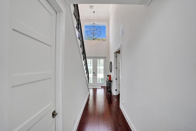 home office with dark wood-type flooring and ornamental molding