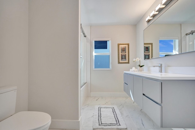 full bathroom with vanity, enclosed tub / shower combo, and toilet