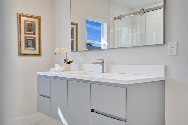 bathroom with vanity and combined bath / shower with glass door