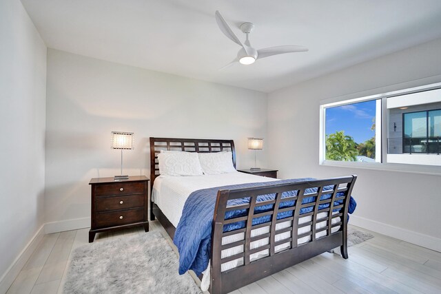 bedroom with a closet, ceiling fan, and light hardwood / wood-style flooring