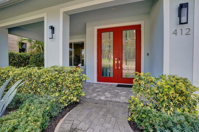 foyer entrance with dark hardwood / wood-style flooring, plenty of natural light, and french doors