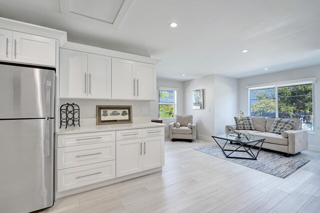 dining room with a healthy amount of sunlight and light hardwood / wood-style flooring