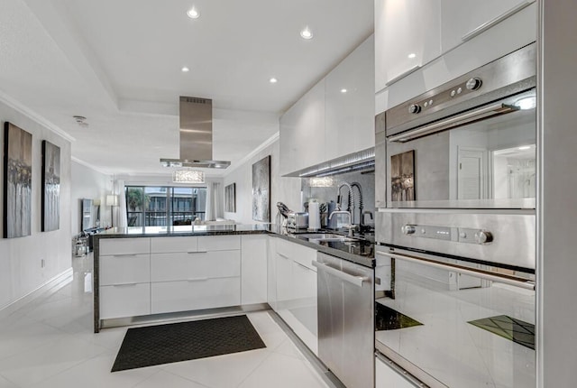 3605 S Ocean Blvd Unit 312, South Palm Beach, FL 33480 - kitchen featuring extractor fan, stainless steel appliances, modern cabinets, and white cabinets