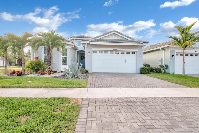 view of front facade with a garage and a front lawn