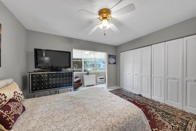 bedroom with ceiling fan, a closet, and a textured ceiling