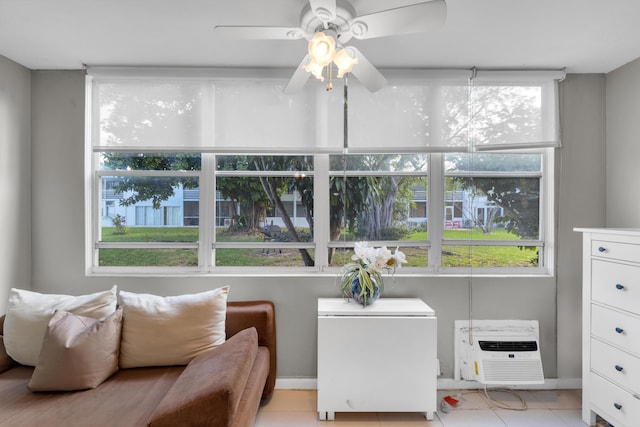 interior space with a wall mounted air conditioner and ceiling fan