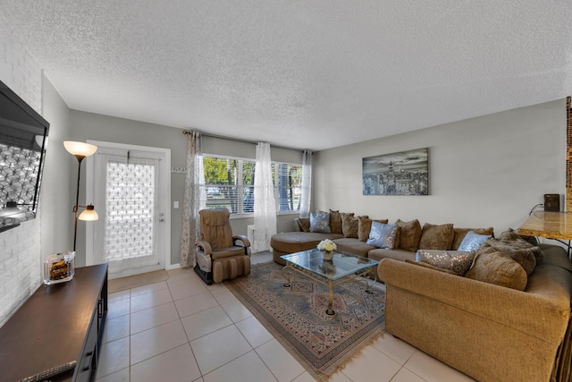 tiled living room featuring a textured ceiling