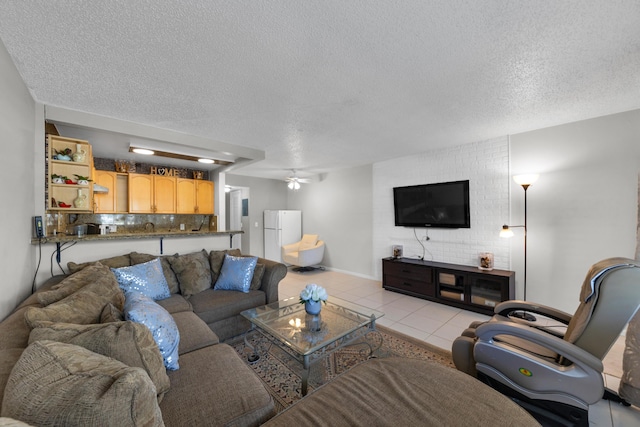 living room with light tile patterned floors, a textured ceiling, and ceiling fan