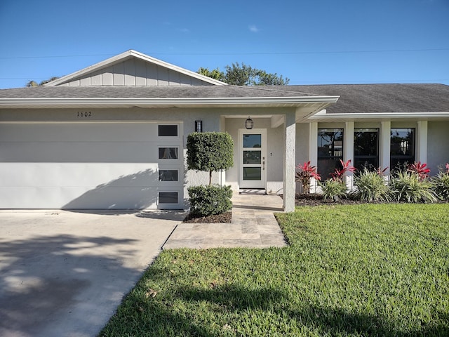 ranch-style house with a garage and a front lawn