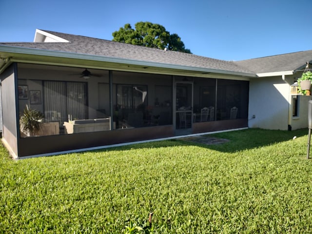 back of property featuring a sunroom, a yard, and ceiling fan