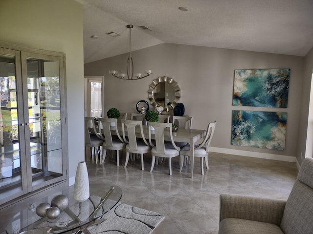 dining space with vaulted ceiling and a notable chandelier