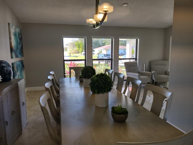 dining room with a notable chandelier and a textured ceiling