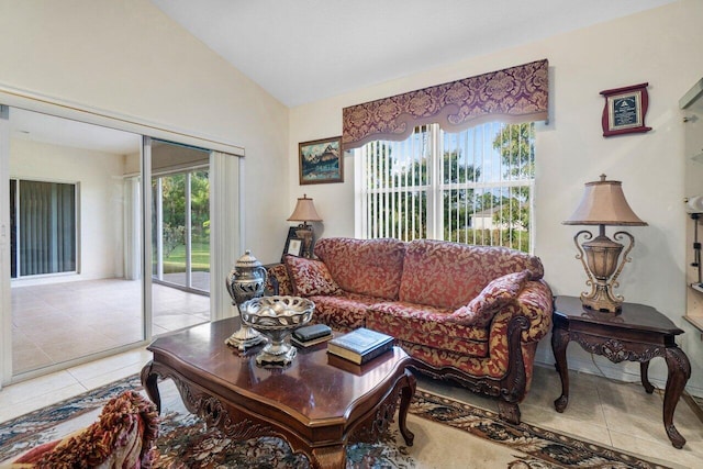 living room featuring light tile patterned floors and vaulted ceiling