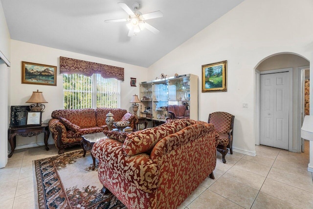 tiled living room featuring ceiling fan and lofted ceiling