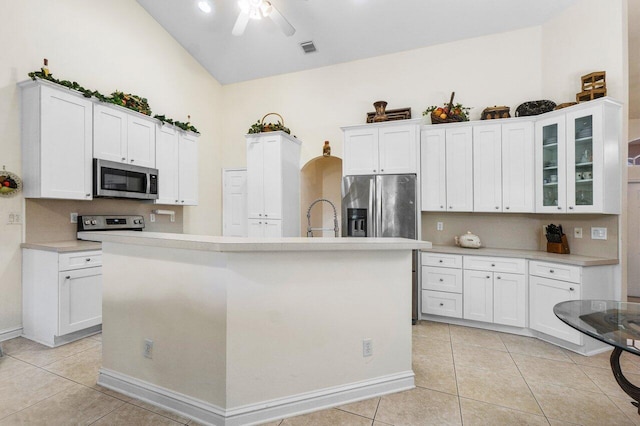 kitchen with white cabinetry, a center island with sink, and appliances with stainless steel finishes