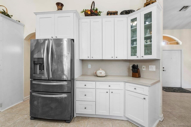 kitchen featuring light tile patterned floors, white cabinets, and stainless steel fridge with ice dispenser