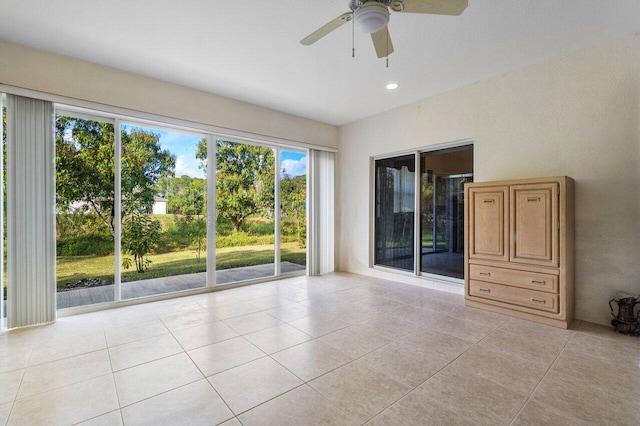 tiled empty room with ceiling fan