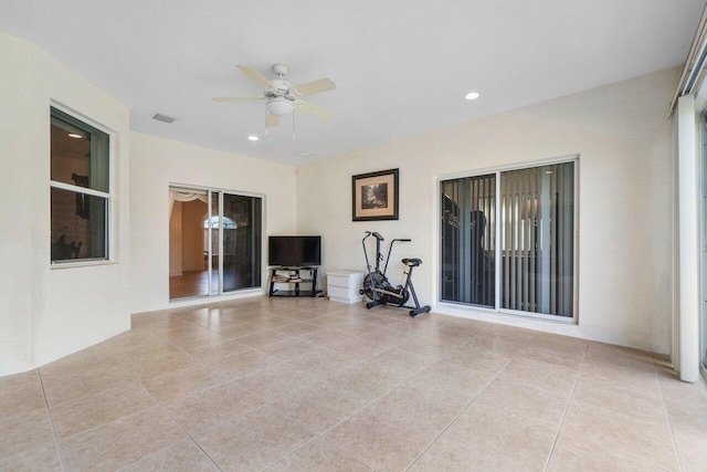 interior space with light tile patterned floors and ceiling fan