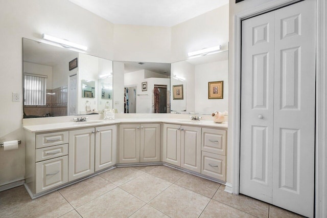 bathroom featuring vanity, a shower, and tile patterned floors