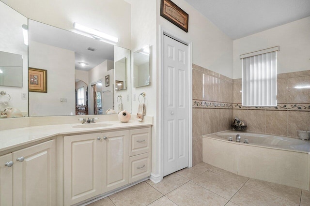 bathroom with vanity, tile patterned flooring, and a bathtub