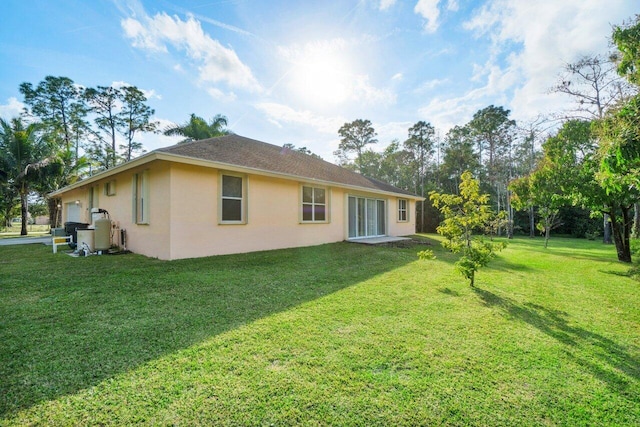 back of house with a lawn