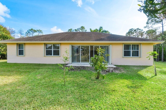 rear view of property with a yard