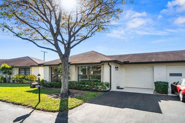 single story home with a garage and a front yard