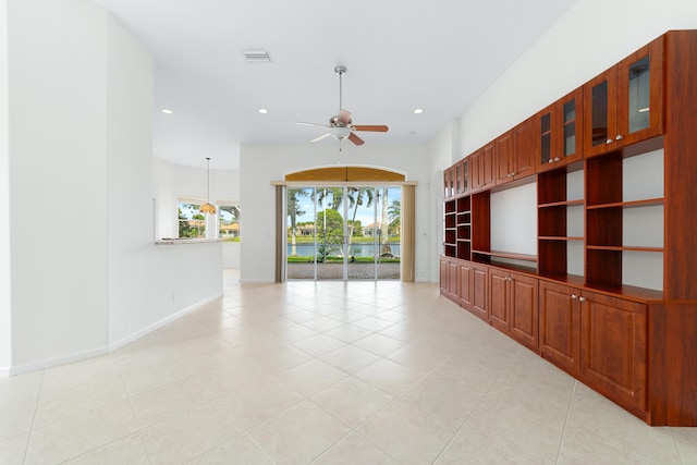 tiled spare room with ceiling fan