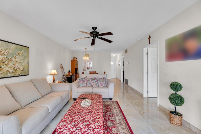 living room featuring ceiling fan with notable chandelier