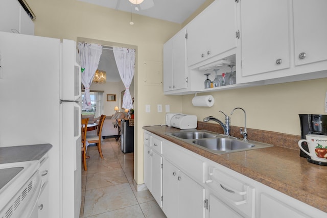 kitchen featuring sink, white cabinets, white fridge, range, and ceiling fan