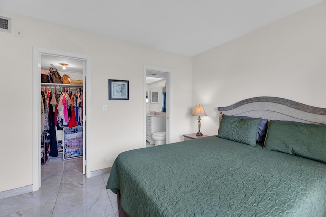 bedroom with sink, connected bathroom, a spacious closet, and a closet