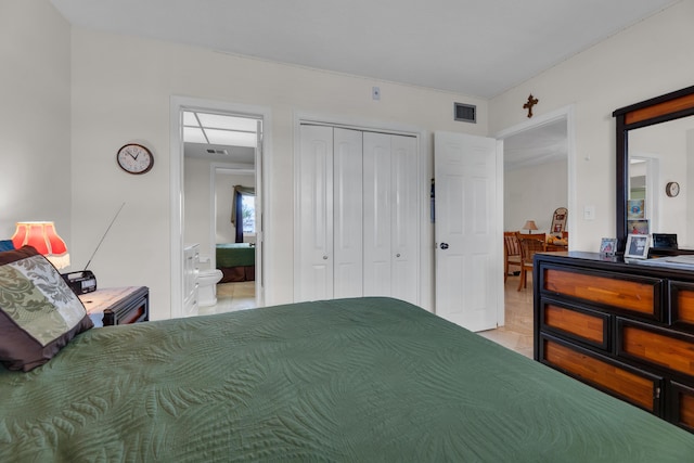 tiled bedroom featuring ensuite bath and a closet