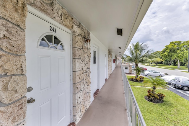 property entrance featuring a lawn