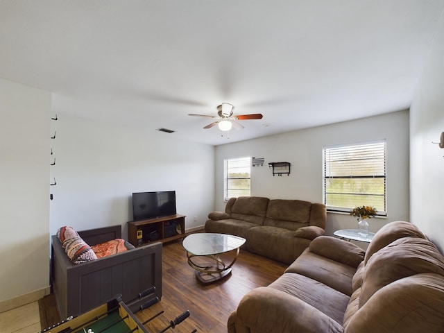 living room with dark wood-type flooring and ceiling fan