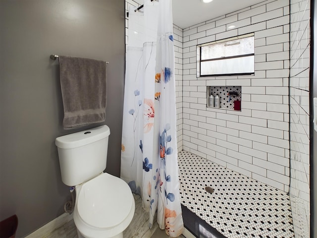 bathroom with a shower with curtain and toilet