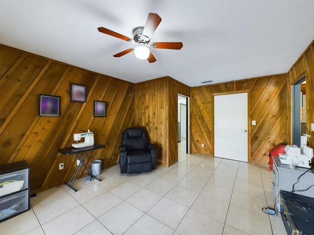 sitting room featuring ceiling fan and light tile patterned floors