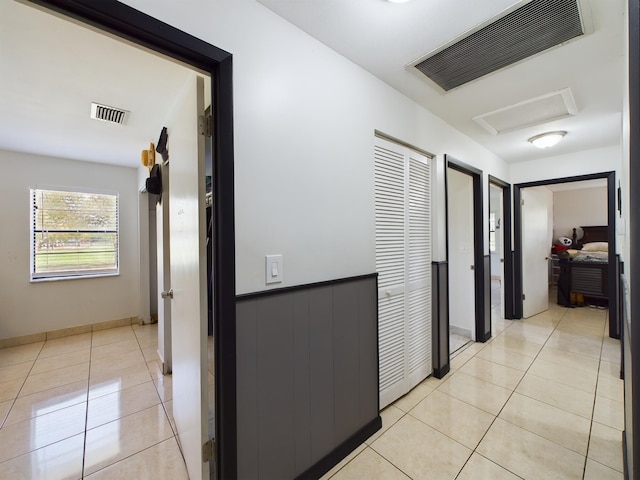 hall featuring light tile patterned flooring