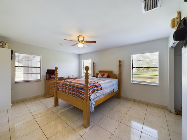 tiled bedroom with ceiling fan