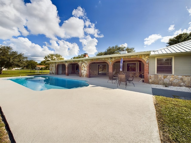 view of pool featuring a patio